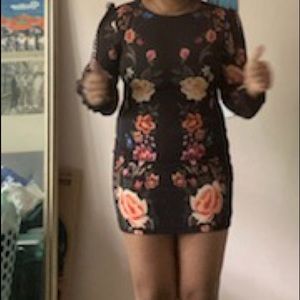 This floral, long sleeve, fitted dress has w/ opened back.